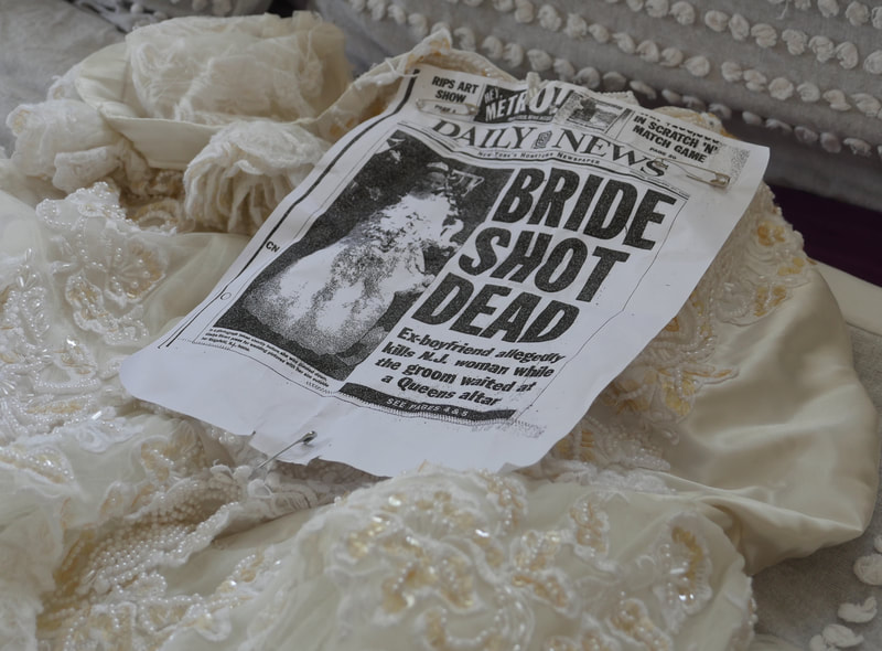 Wedding dress with copy of Daily News front page article about the death of Gladys Ricart.